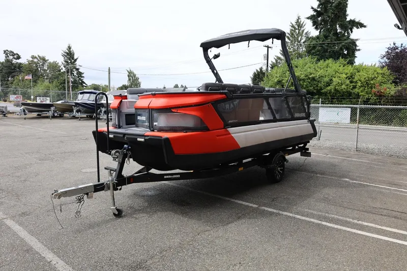 Slide: The Image of 2022 Sea-Doo Switch Cruise 21 on trailer in parking lot, side view. - 7