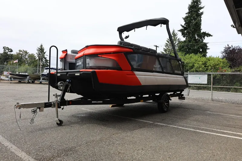 Slide: The Image of 2022 Sea-Doo Switch Cruise 21 on trailer, parked outdoors, showcasing sleek design and vibrant colors. - 8