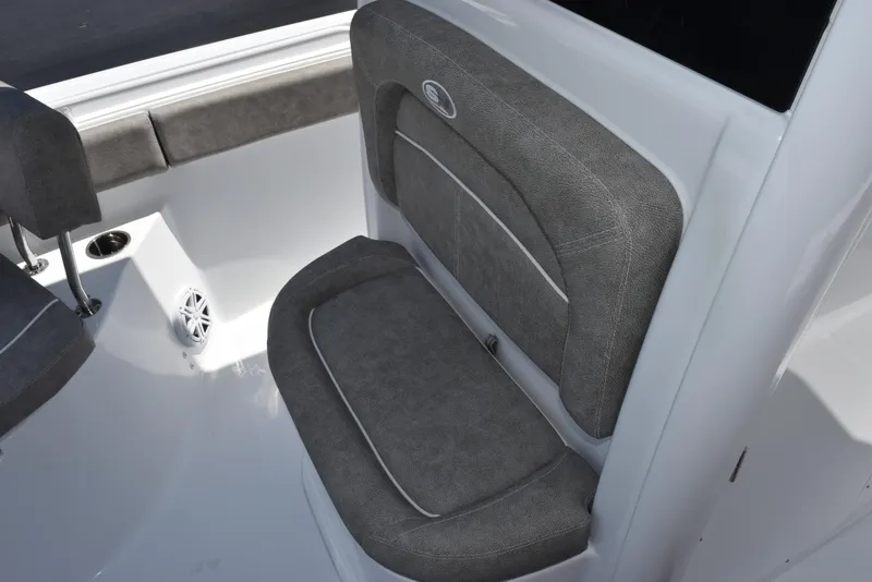Slide: The Image of 2026 Sea Hunt Ultra 235 SE boat interior with gray cushioned seating. - 10