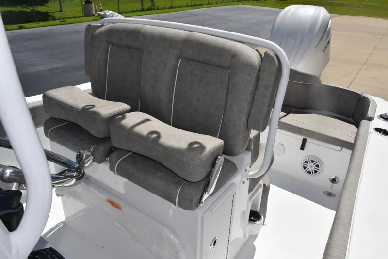 Slide: The Image of 2026 Sea Hunt Ultra 235 SE boat interior with cushioned seating and steering wheel. - 11