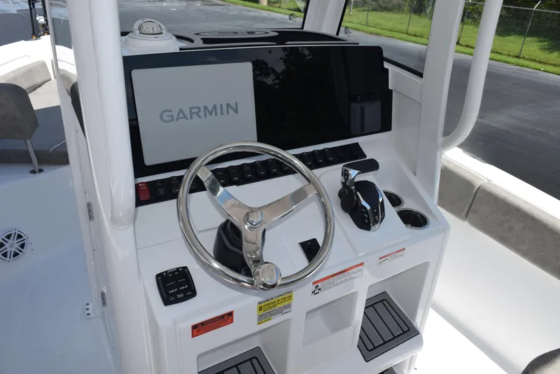 Slide: The Image of 2026 Sea Hunt Ultra 235 SE boat console with Garmin display and steering wheel. - 12