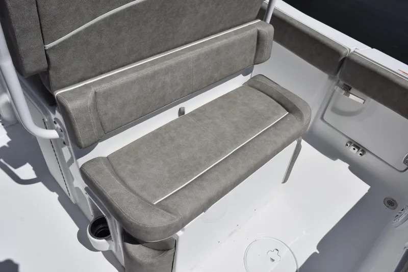 Slide: The Image of 2026 Sea Hunt Ultra 235 SE boat seating with gray upholstery and white accents. - 15