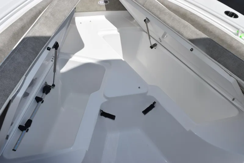 Slide: The Image of Interior view of 2026 Sea Hunt Ultra 235 SE boat, featuring spacious seating and storage. - 19