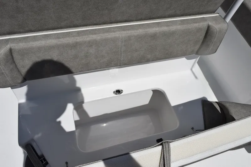 Slide: The Image of 2026 Sea Hunt Ultra 235 SE boat storage compartment with cushioned seating. - 21