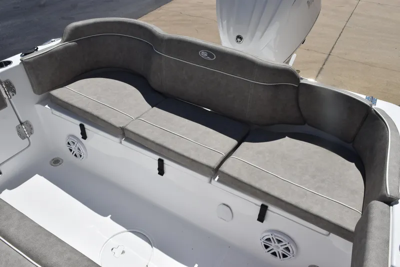Slide: The Image of 2026 Sea Hunt Ultra 235 SE boat with cushioned seating and integrated speakers. - 24