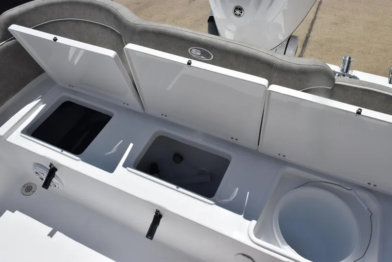 Slide: The Image of 2026 Sea Hunt Ultra 235 SE boat storage compartments and seating area. - 25
