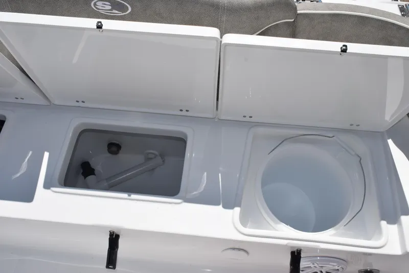 Slide: The Image of 2026 Sea Hunt Ultra 235 SE boat storage compartments with open lids, showcasing interior features. - 26