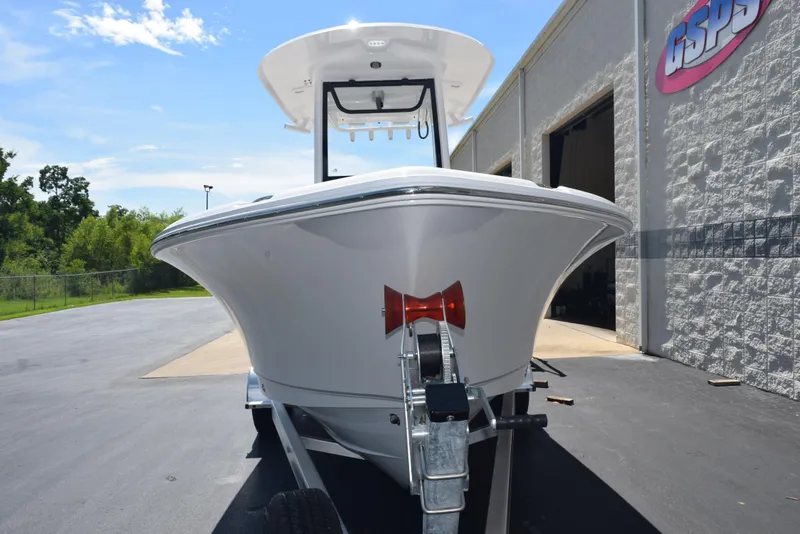 Slide: The Image of 2026 Sea Hunt Ultra 235 SE boat on trailer, parked outside a building. - 3