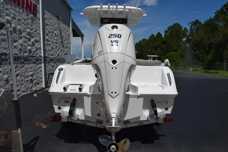 Slide: The Image of 2026 Sea Hunt Ultra 235 SE boat with powerful V6 engine, parked outdoors. - 5