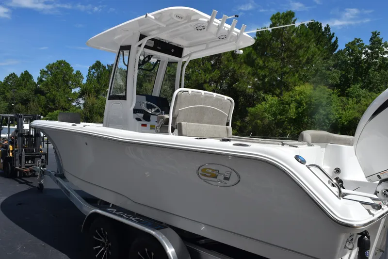 Slide: The Image of 2026 Sea Hunt Ultra 235 SE boat on trailer, parked outdoors. - 6