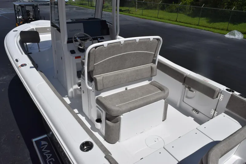 Slide: The Image of 2026 Sea Hunt Ultra 235 SE boat interior with gray seating and steering console. - 7