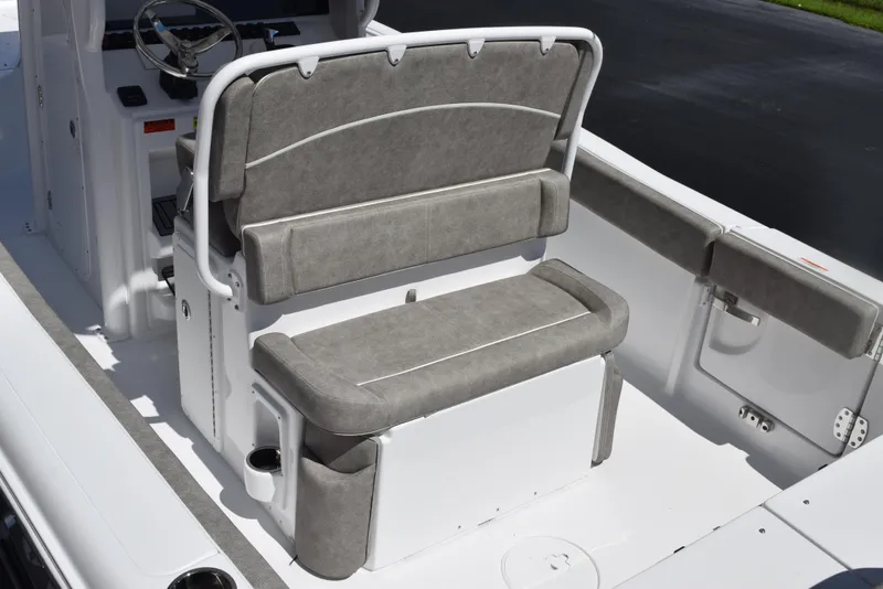 Slide: The Image of 2026 Sea Hunt Ultra 235 SE boat interior with gray cushioned seating and steering console. - 8