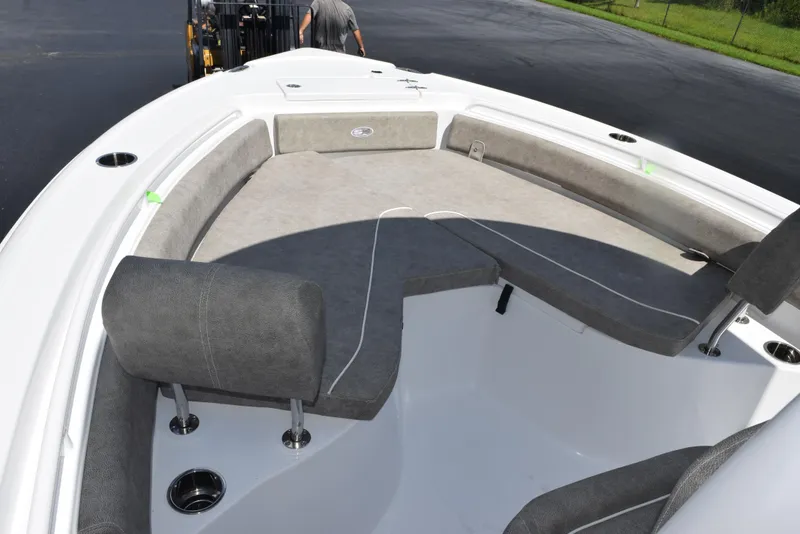 Slide: The Image of 2026 Sea Hunt Ultra 235 SE boat interior with cushioned seating and cup holders. - 9