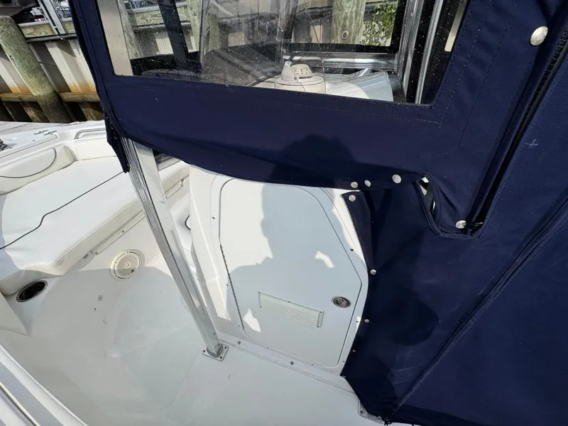 Slide: The Image of 2014 Sea Hunt Ultra 196 boat interior with portable toilet and fire extinguisher. - 16