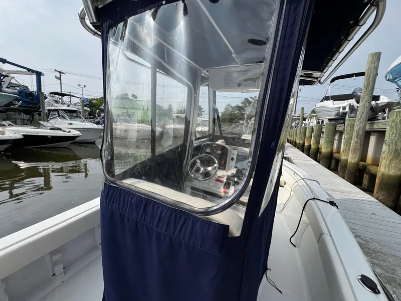 Slide: The Image of 2014 Sea Hunt Ultra 196 boat with Yamaha outboard engine, docked at marina. - 4
