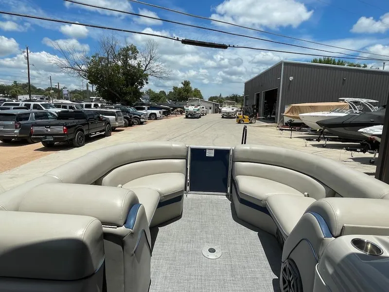 Slide: The Image of 2017 South Bay 500 pontoon boat with spacious seating, parked outdoors under a blue sky. - 10