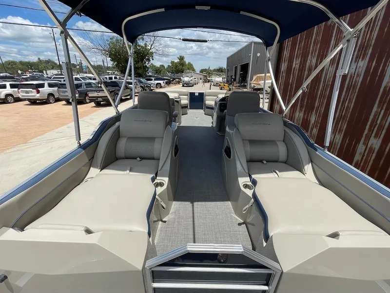 Slide: The Image of 2017 South Bay 500 pontoon boat with spacious seating and canopy, parked outdoors. - 4