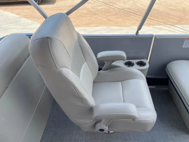 Slide: The Image of Luxurious white captain's chair on a 2017 South Bay 500 boat, featuring cup holders. - 6