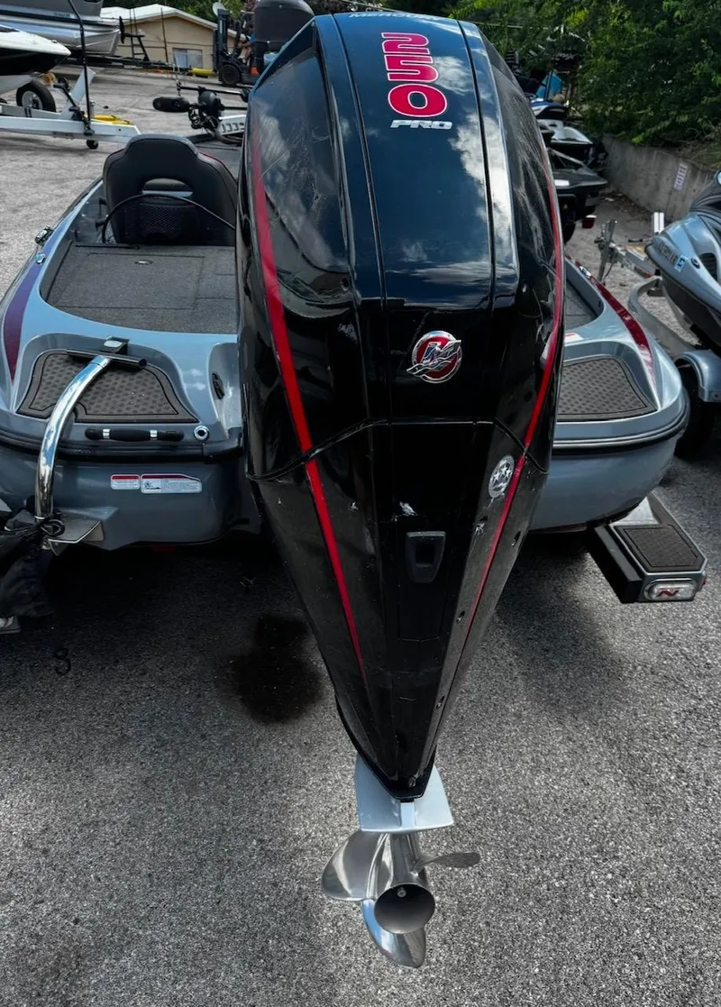 Slide: The Image of 2021 Tracker Nitro Z21 SC boat with powerful outboard motor, parked on concrete surface. - 10