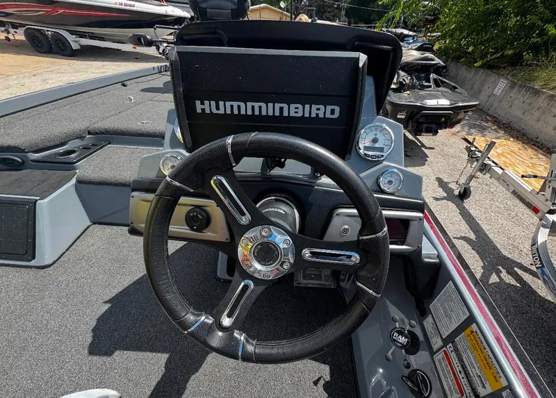 Slide: The Image of 2021 Tracker Nitro Z21 SC boat dashboard with Humminbird display and steering wheel. - 3