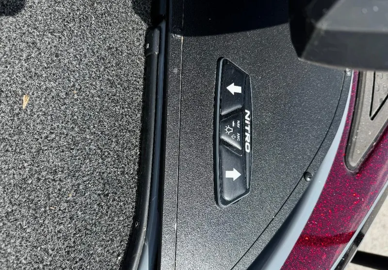 Slide: The Image of 2021 Tracker Nitro Z21 SC boat control panel with directional buttons. - 6