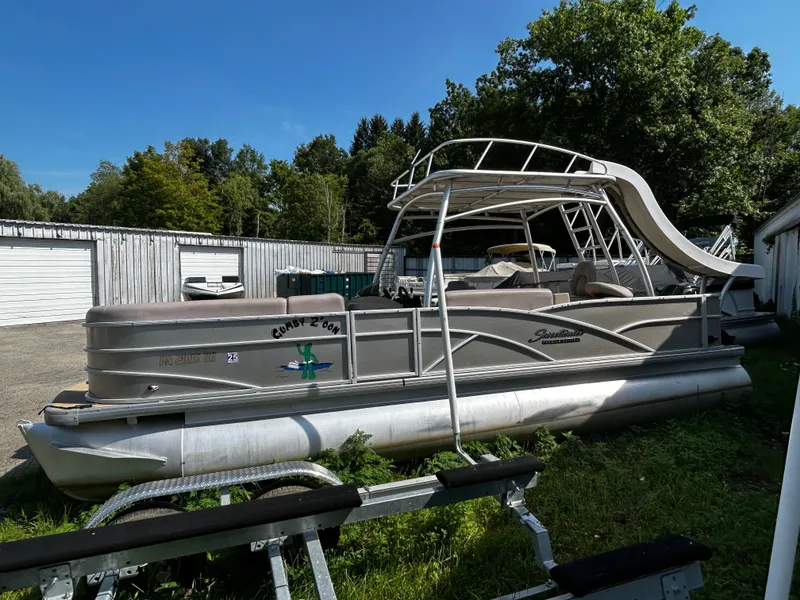 Slide: The Image of 2015 Sweetwater Premium Edition 240 pontoon boat parked outdoors. - 10