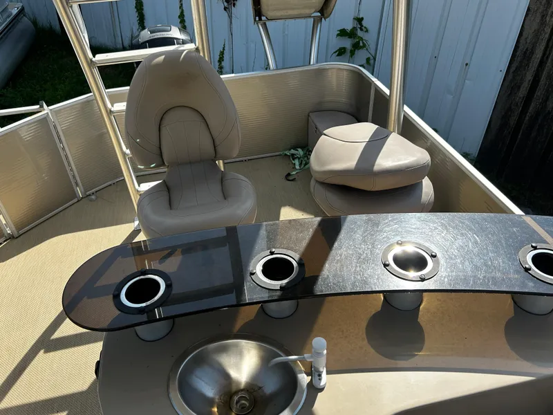 Slide: The Image of Interior of 2015 Sweetwater Premium Edition 240 boat with seating and cup holders. - 8