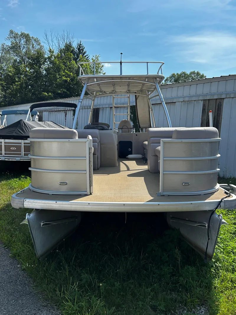 Slide: The Image of 2015 Sweetwater Premium Edition 240 pontoon boat, docked outdoors, sunny day. - 9