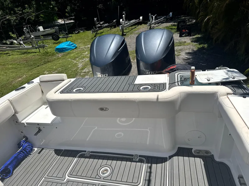 Slide: The Image of 2021 Sea Hunt Gamefish 30 Coffin Box boat with twin Yamaha 300 engines, docked outdoors. - 11