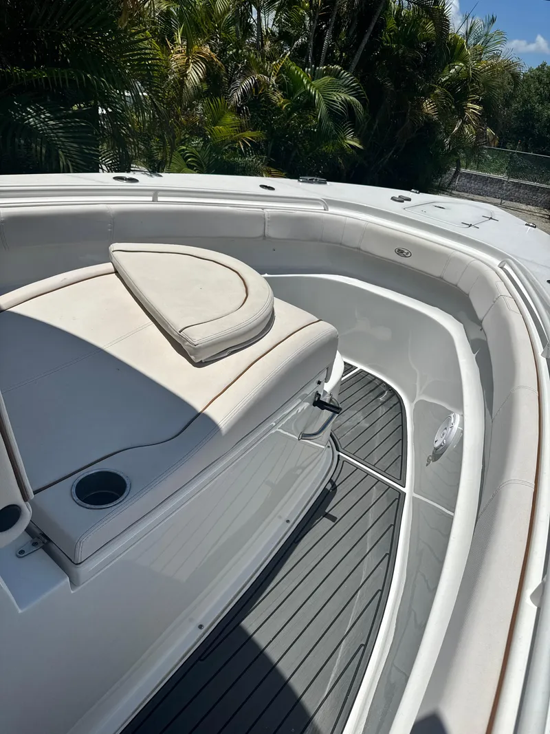 Slide: The Image of 2021 Sea Hunt Gamefish 30 Coffin Box boat interior with cushioned seating and cup holders. - 12