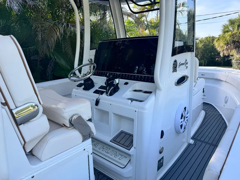 Slide: The Image of 2021 Sea Hunt Gamefish 30 Coffin Box boat interior with steering console and seating. - 5