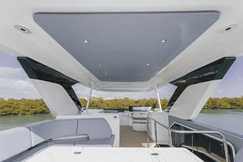 Slide: The Image of Luxurious 2025 Cruisers Yachts 57 Fly deck with modern seating and sleek design. - 14