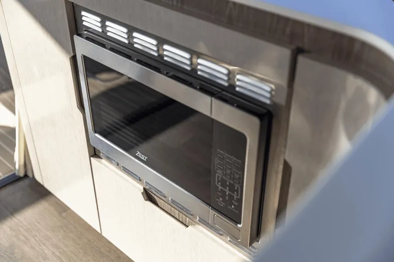 Slide: The Image of Built-in microwave in 2025 Cruisers Yachts 57 Fly, modern kitchen appliance. - 28