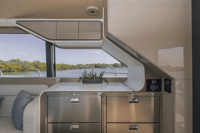 Slide: The Image of Modern interior of 2025 Cruisers Yachts 57 Fly with sleek cabinetry and scenic window view. - 29
