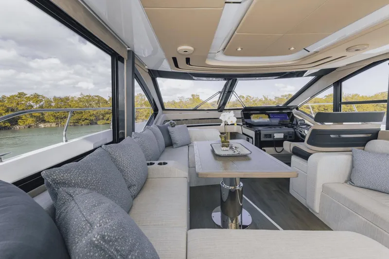 Slide: The Image of Luxurious interior of 2025 Cruisers Yachts 57 Fly with modern seating and panoramic windows. - 33