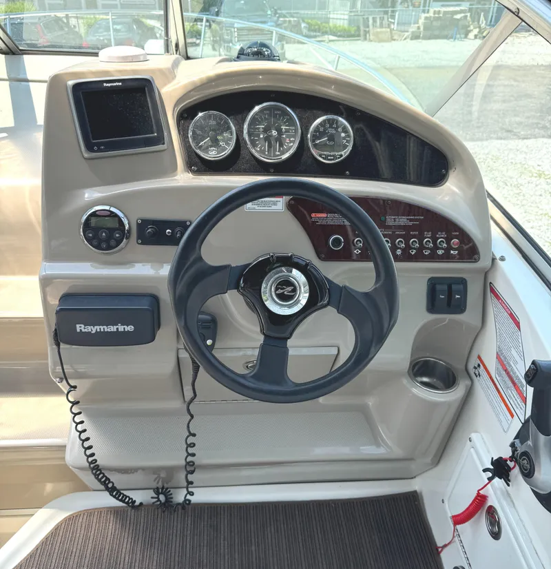 Slide: The Image of Dashboard of a 2008 Sea Ray 240 Sundancer boat with steering wheel and gauges. - 12