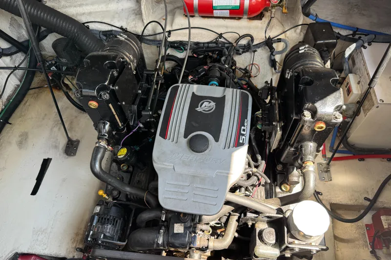 Slide: The Image of Engine compartment of a 2008 Sea Ray 240 Sundancer boat, featuring a Mercury 5.0L engine. - 26