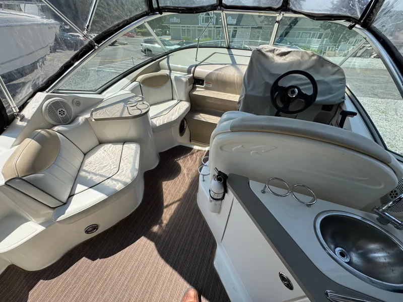Slide: The Image of 2008 Sea Ray 240 Sundancer boat interior with seating, steering wheel, and sink. - 5