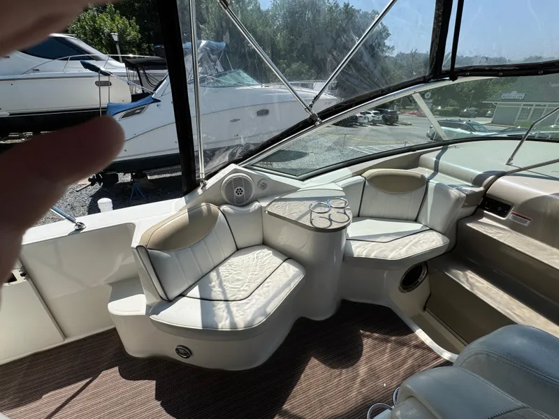 Slide: The Image of 2008 Sea Ray 240 Sundancer boat interior with white seating and cup holders. - 8