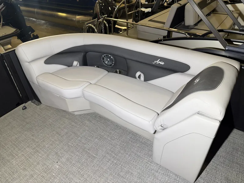 Slide: The Image of The image shows an elegant, light-colored seating area on a boat with gray carpeting. - 18
