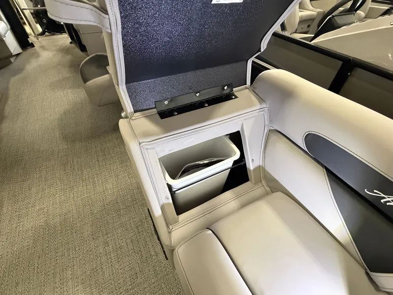 Slide: The Image of The image shows the interior of a Barletta Aria 22 QC boat with a built-in trash bin. - 5