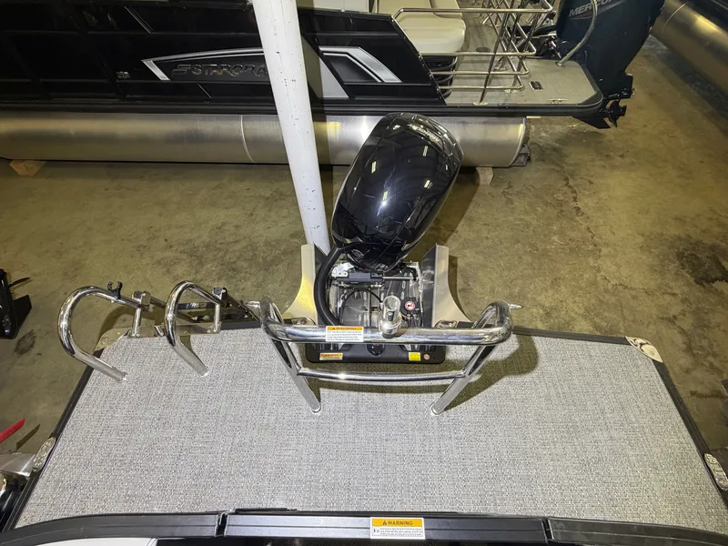 Slide: The Image of The image shows the engine area of a Barletta Aria 22 QC pontoon boat with an outboard motor. - 21