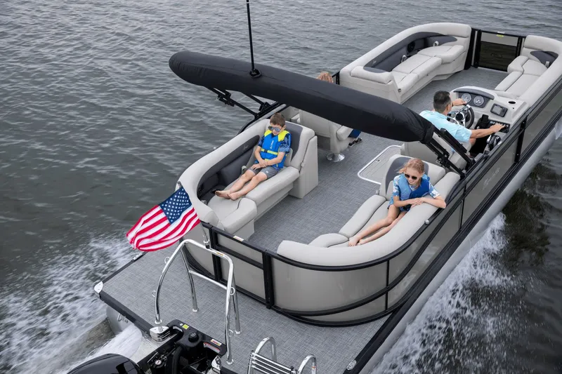 Slide: The Image of 2026 Barletta Aria 24 QC pontoon boat on water with passengers. - 3