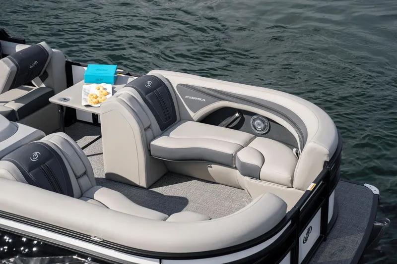 Slide: The Image of 2026 Barletta Corsa 23 U pontoon boat displayed at a trade show. - 2