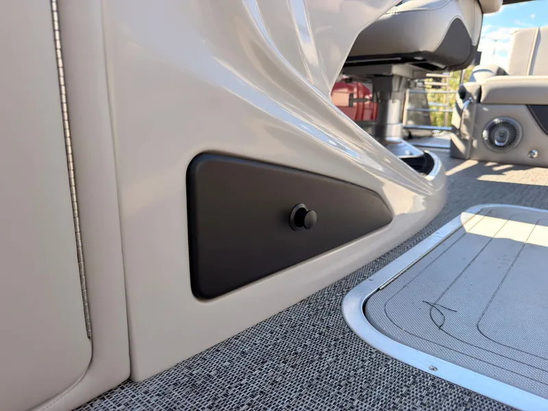Slide: The Image of Close-up of a sleek boat interior with gray carpeting and a black control knob. - 34