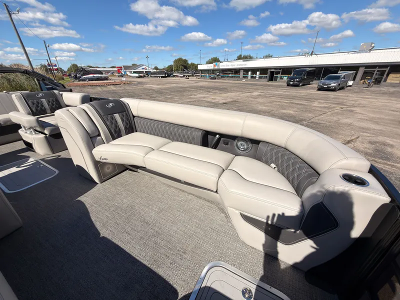 Slide: The Image of The image shows the luxurious interior of a Barletta Lusso 25 U pontoon boat with elegant seating. - 14