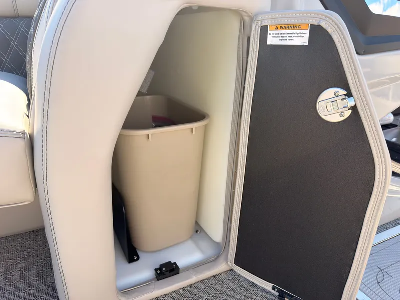 Slide: The Image of A storage compartment on a Barletta Lusso 25 U boat with a trash bin inside. - 33