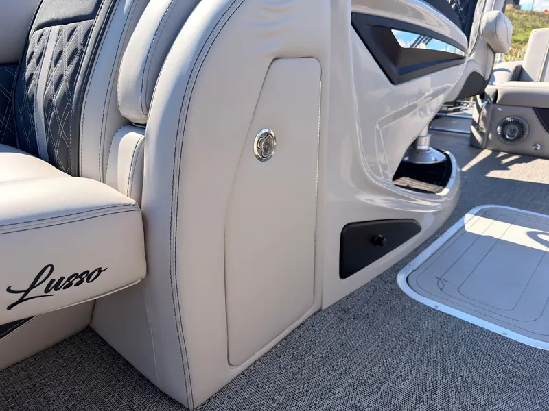Slide: The Image of Close-up of a sleek, modern boat interior with beige upholstery and "Lusso" branding. - 32