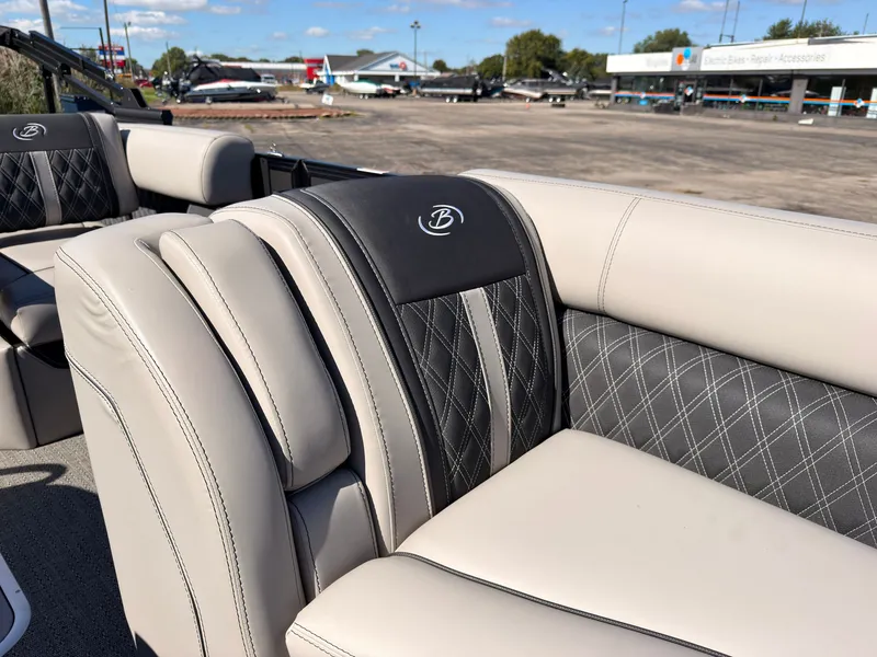 Slide: The Image of The 2026 Barletta Lusso 25 U features luxurious, upholstered seating with elegant stitching. - 21