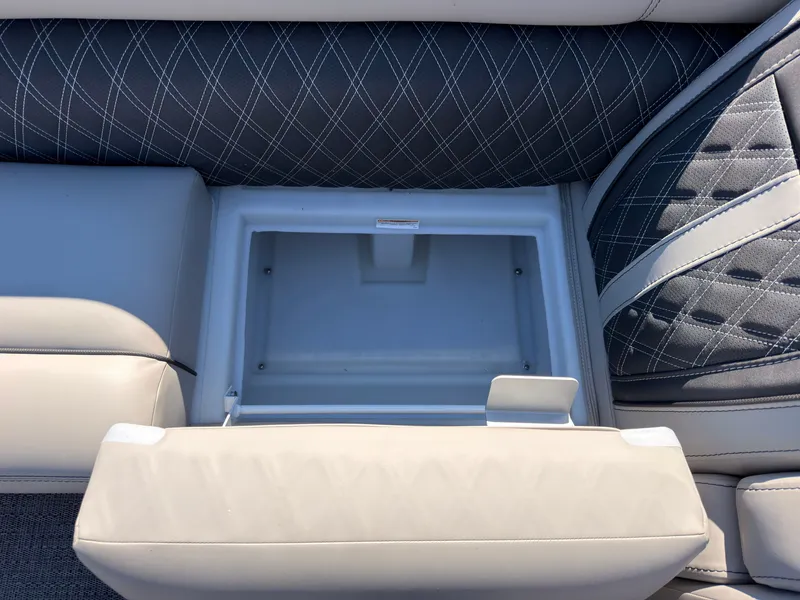 Slide: The Image of An open storage compartment on a Barletta Lusso 25 U boat with cushioned seating. - 29